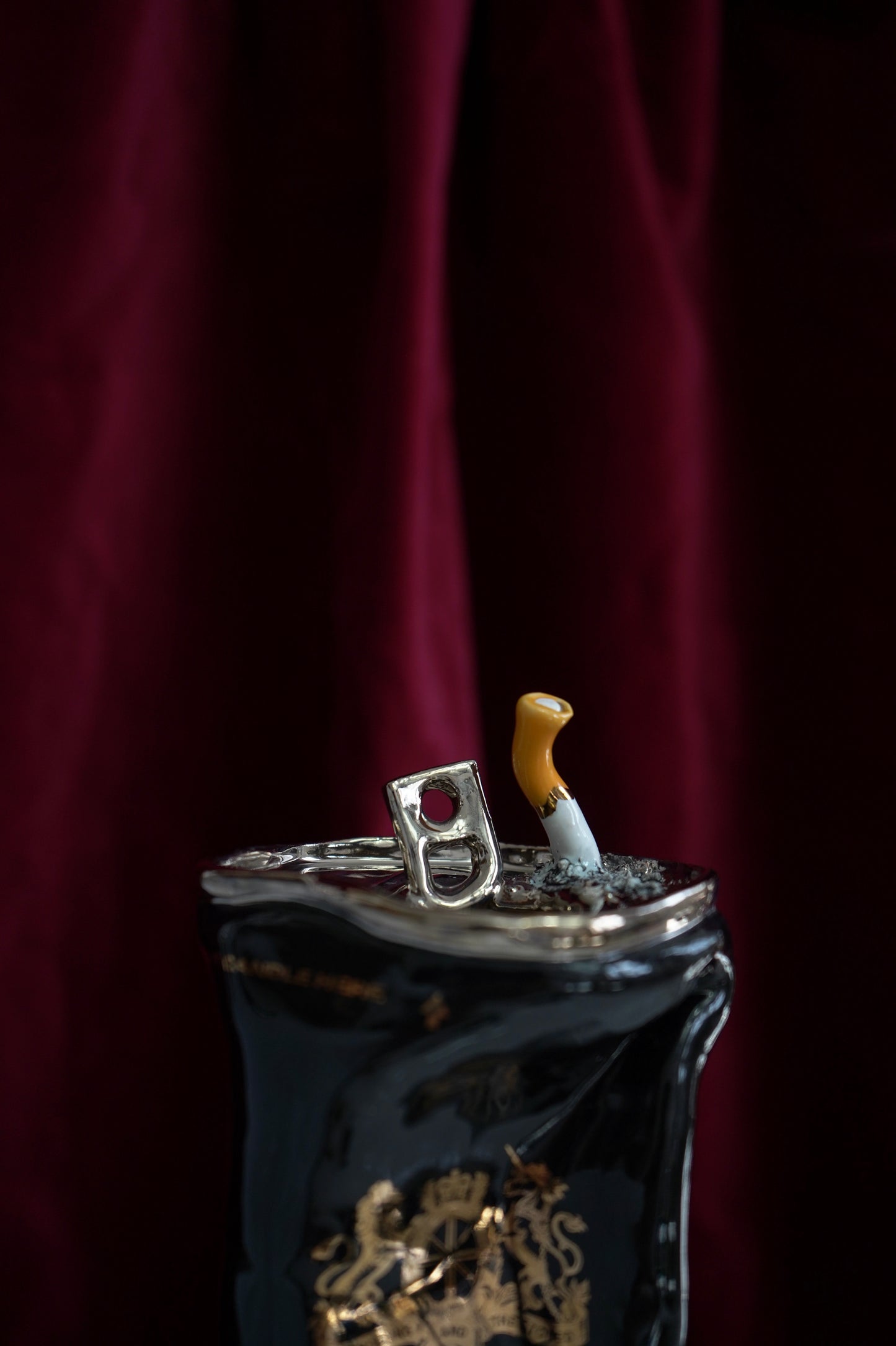 SILVER STUBBED OUT CIGARETTE BEER CAN