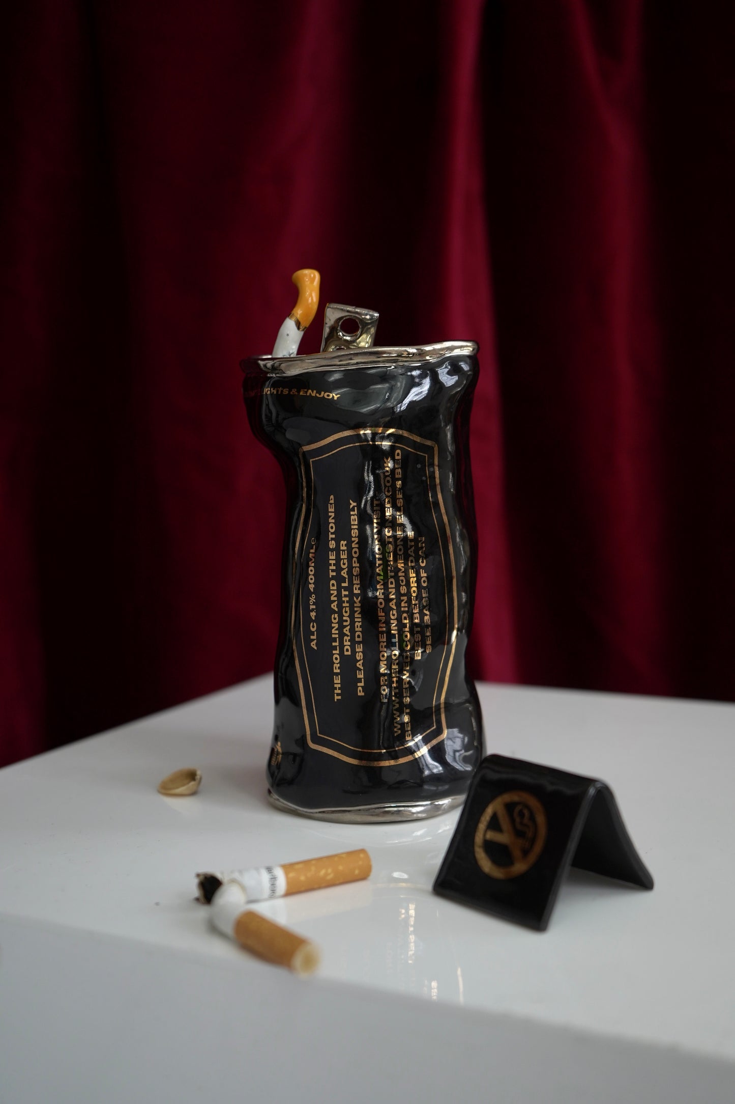 SILVER STUBBED OUT CIGARETTE BEER CAN