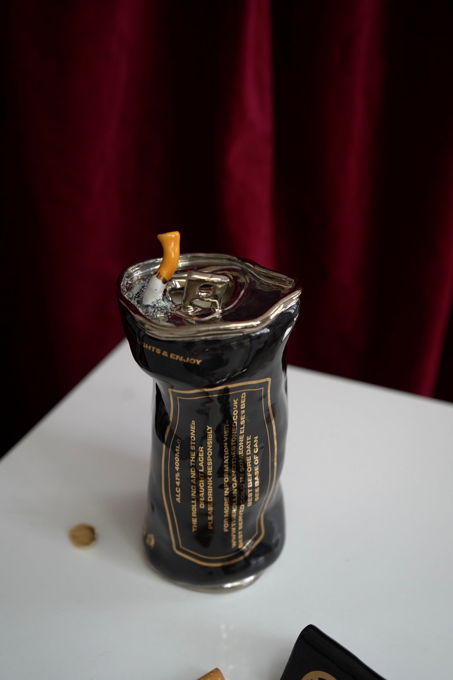 SILVER STUBBED OUT CIGARETTE BEER CAN