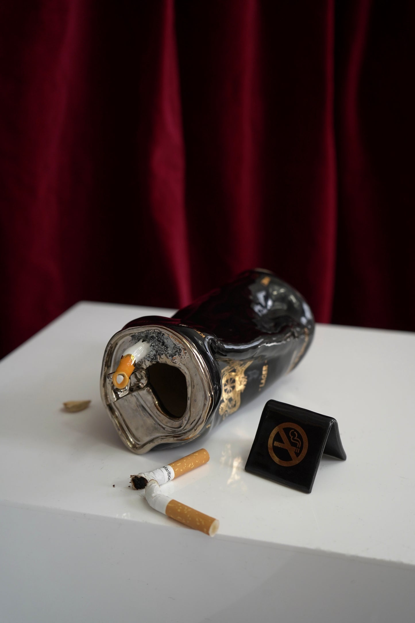 SILVER STUBBED OUT CIGARETTE BEER CAN